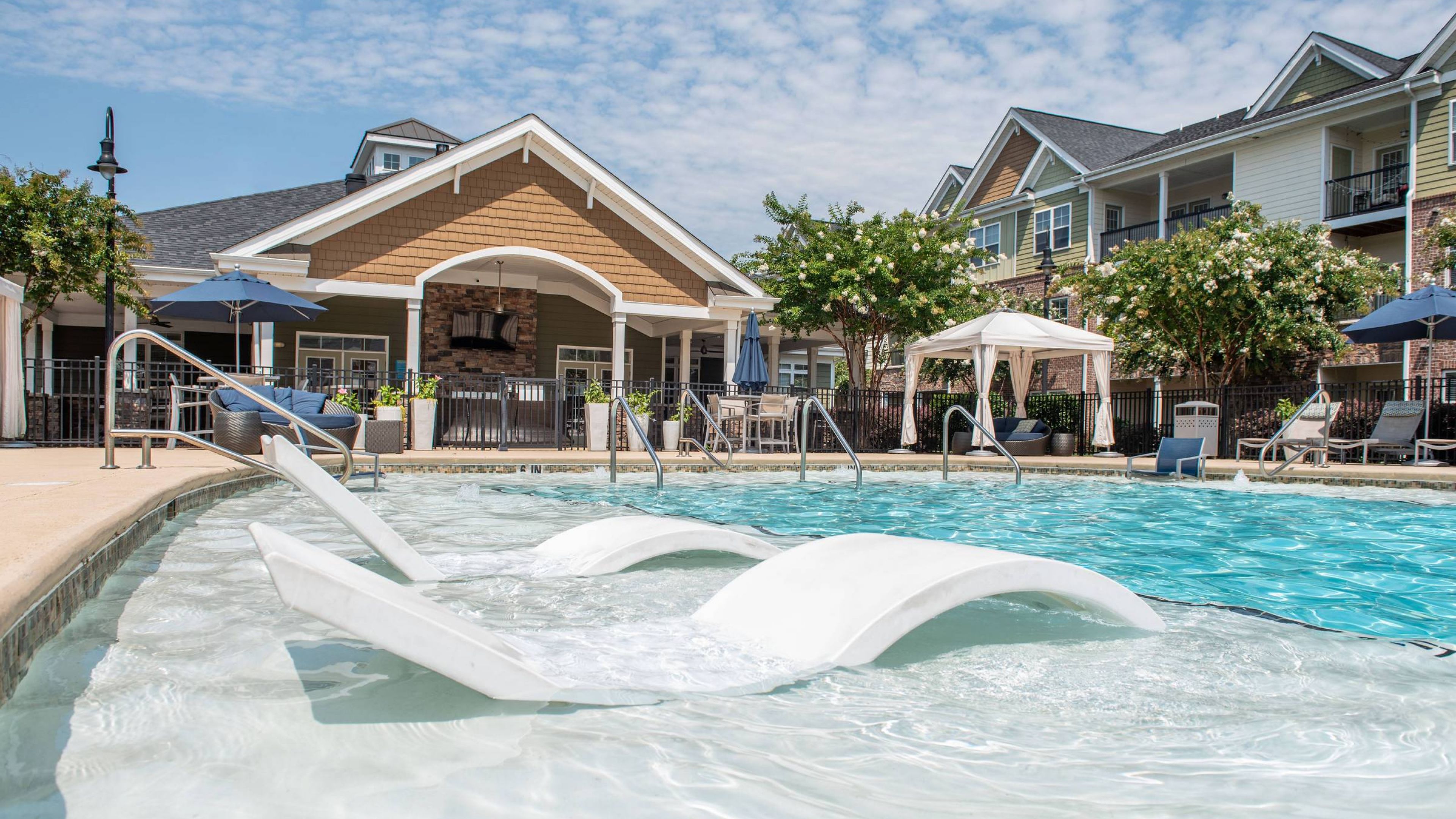 Hawthorne at the Summit luxury outdoor pool with in-pool lounge chairs and surrounding seating